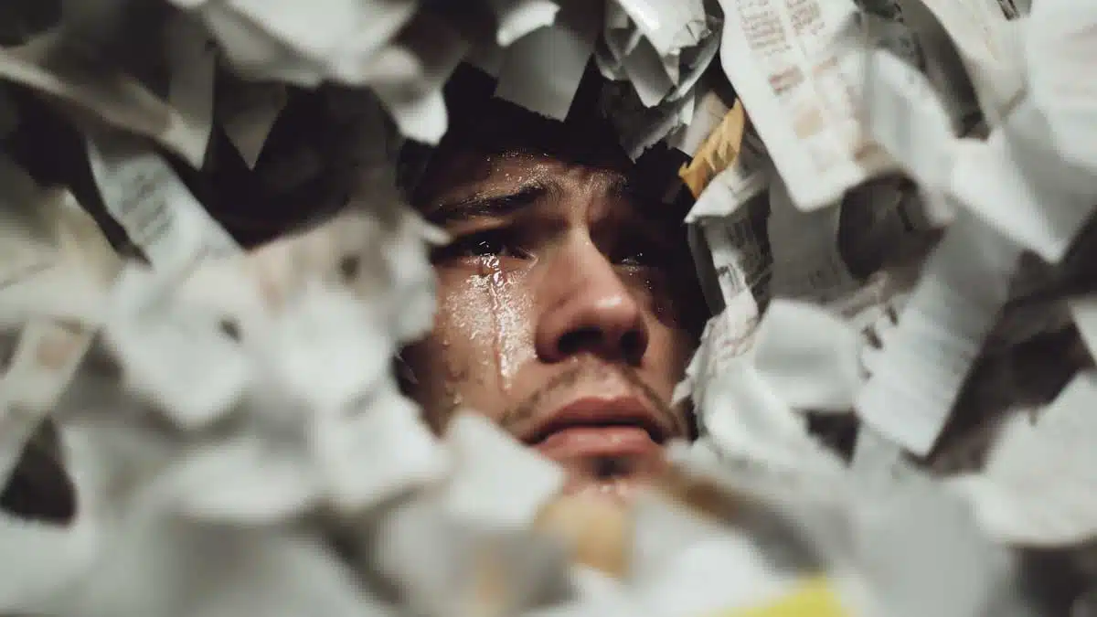Man overwhelmed by expense reports