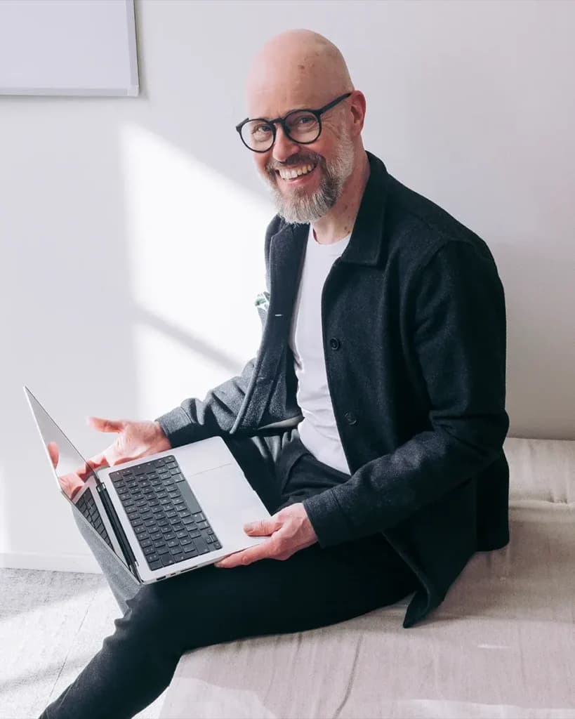 Freelancer smiling with a laptop while email receipts are collected automatically