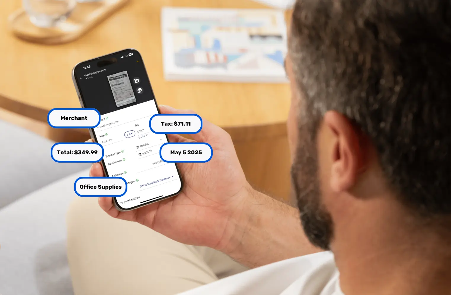 A man scanning receipts with the SparkReceipt mobile application