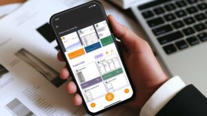 Man holding phone with business app