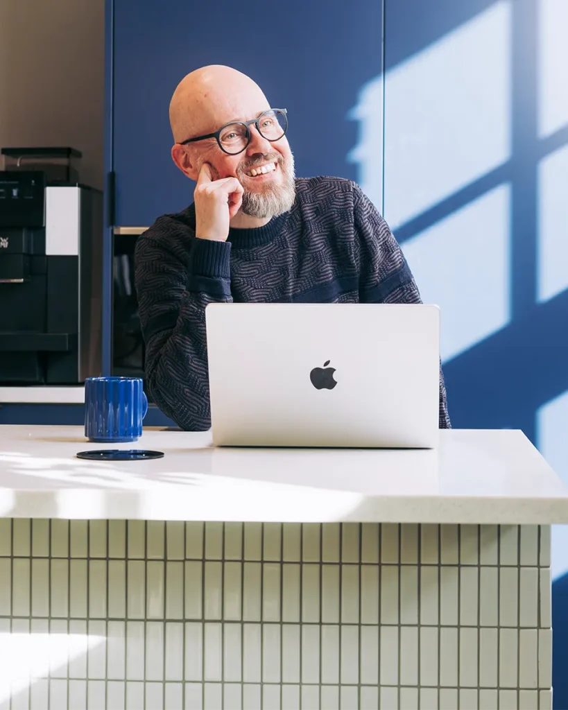 Happy accountant smiling because he doesn't have to deal with shoeboxes filled with receipts