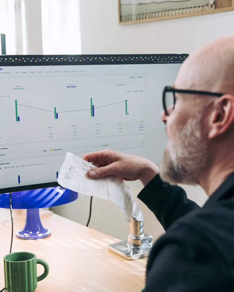 Accountant looking at expenses and income on a screen