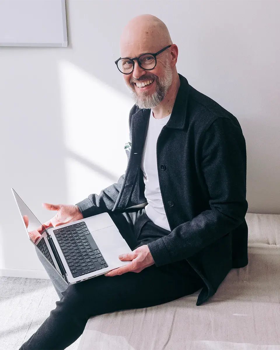 Happy accountant smiling with laptop in lap