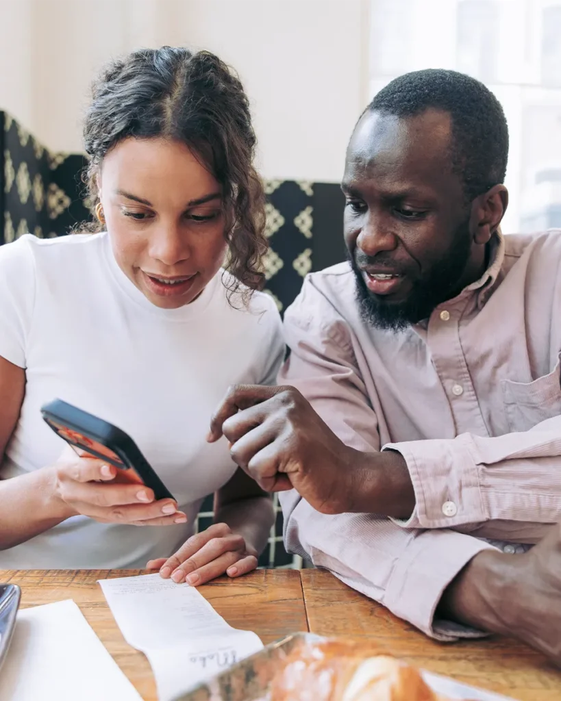 Two people looking at SparkReceipt mobile application after scanning a receipt