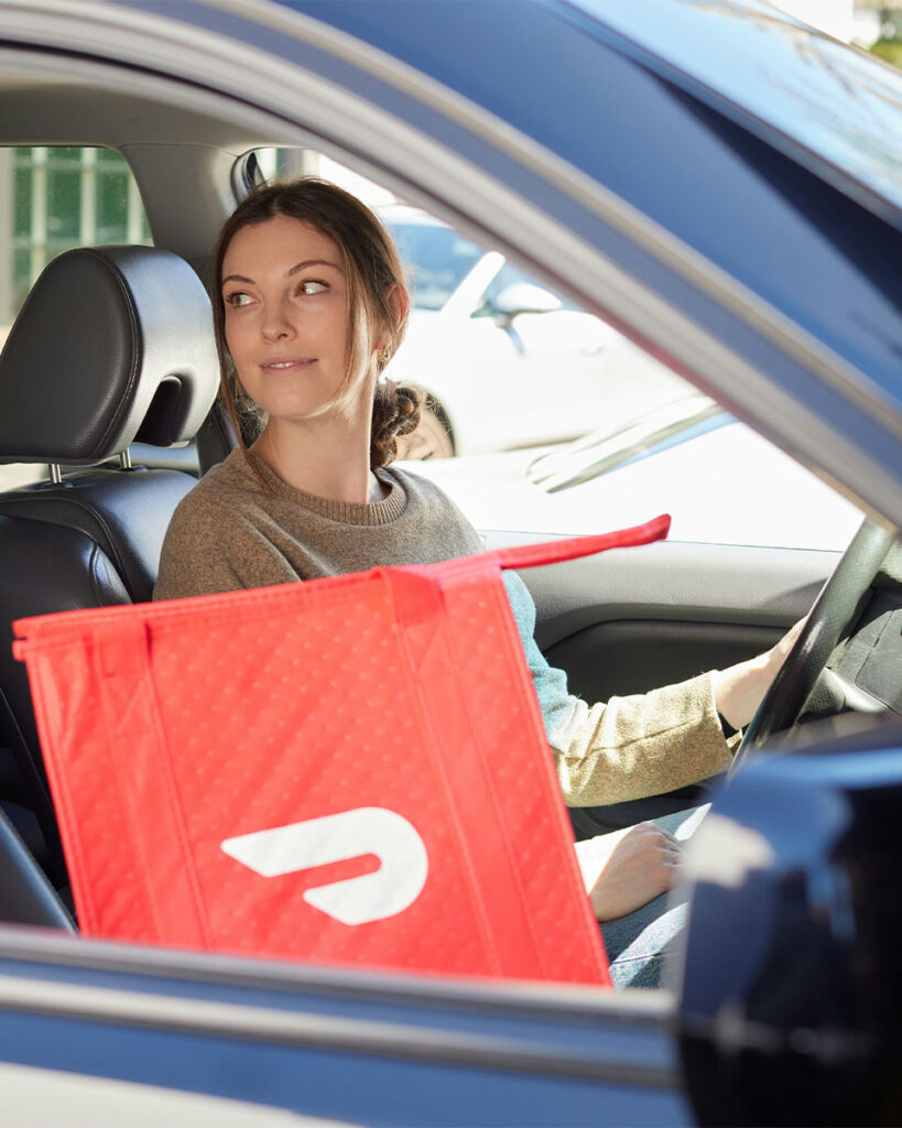 Woman doing a delivery in a car